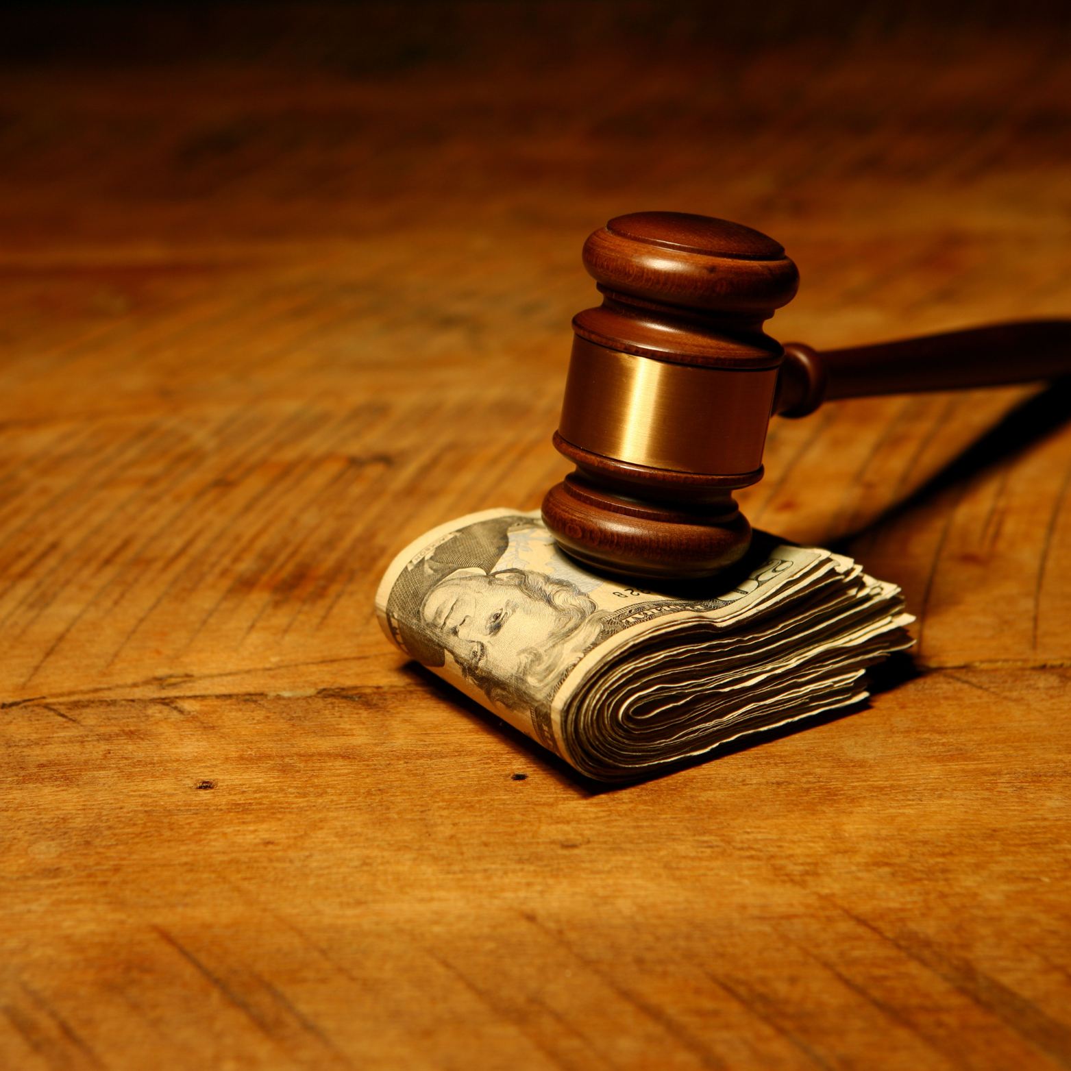 Legal gavel resting on stack of money representing successful MVA settlements